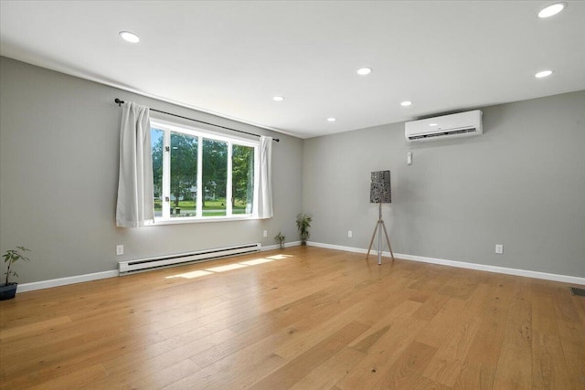 52 Bull Pine Rd, East Stroudsburg, PA 18301 - unfurnished room with a baseboard heating unit, a wall mounted air conditioner, recessed lighting, and light wood-style floors