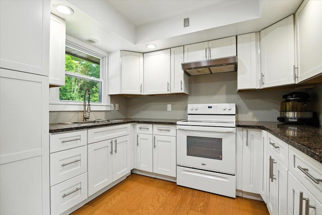 52 Bull Pine Rd, East Stroudsburg, PA 18301 - kitchen featuring white range with electric cooktop, under cabinet range hood, white cabinetry, light wood-style floors, and dark stone counters