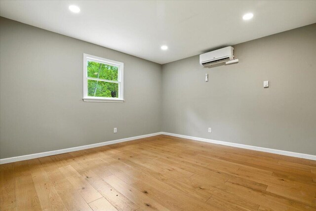 52 Bull Pine Rd, East Stroudsburg, PA 18301 - empty room with an AC wall unit, light wood finished floors, and recessed lighting