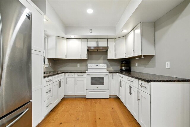 52 Bull Pine Rd, East Stroudsburg, PA 18301 - kitchen with freestanding refrigerator, white range with electric stovetop, under cabinet range hood, recessed lighting, and white cabinetry