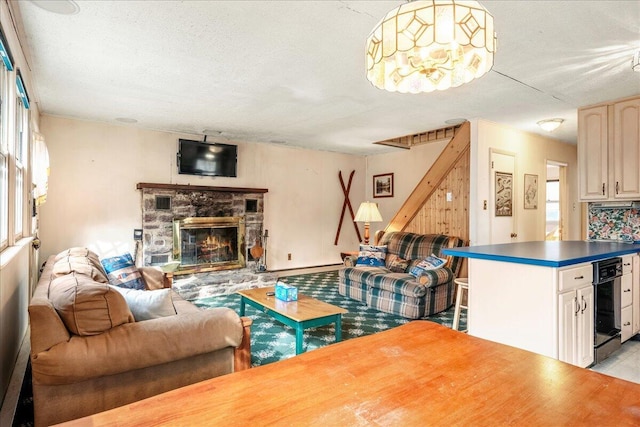 living room with a fireplace and a textured ceiling
