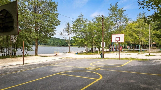view of sport court featuring community basketball court, a water view, and playground community