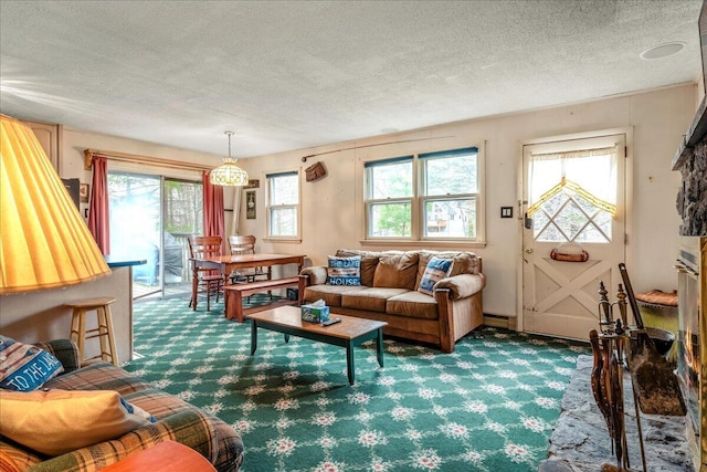 carpeted living area featuring a textured ceiling and baseboard heating