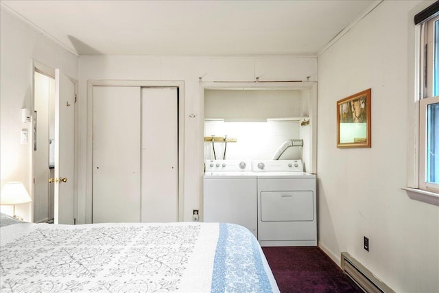 bedroom with crown molding, washer and clothes dryer, a closet, a baseboard heating unit, and dark carpet