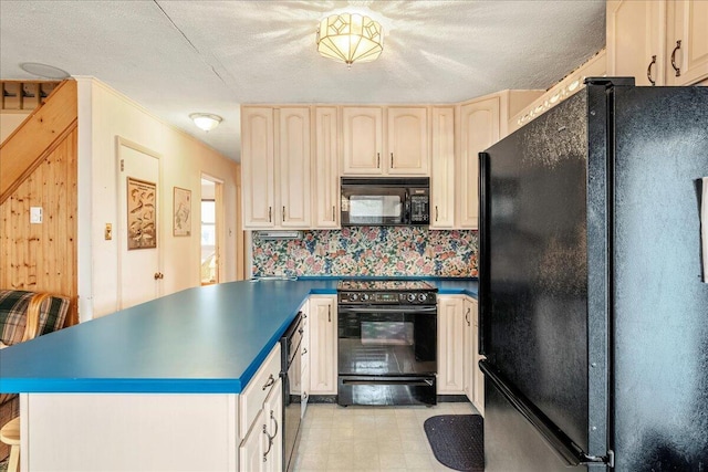 kitchen with a peninsula, dark countertops, a textured ceiling, and black appliances