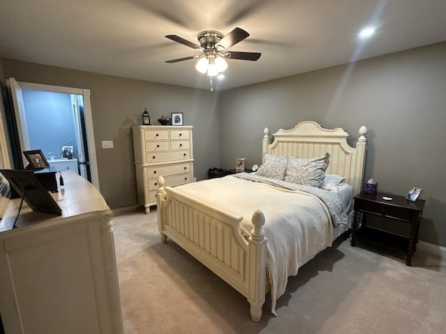 bedroom featuring light carpet, baseboards, and ceiling fan