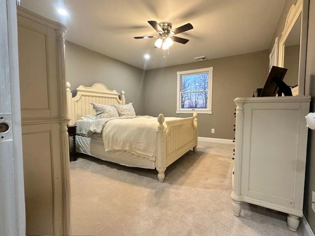 bedroom with ceiling fan, baseboards, visible vents, and light carpet