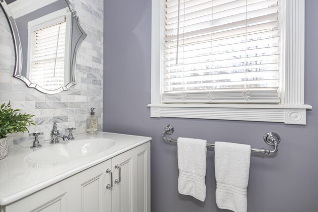 bathroom featuring tasteful backsplash and vanity