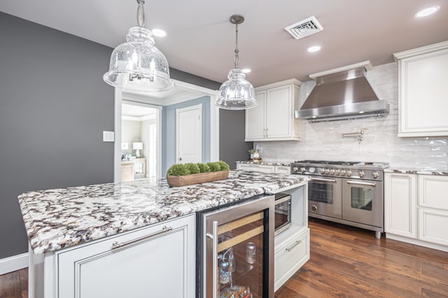 kitchen featuring visible vents, dark wood-type flooring, double oven range, wine cooler, and wall chimney exhaust hood