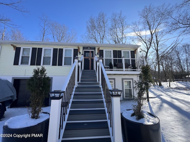 view of front of house featuring a garage and stairway