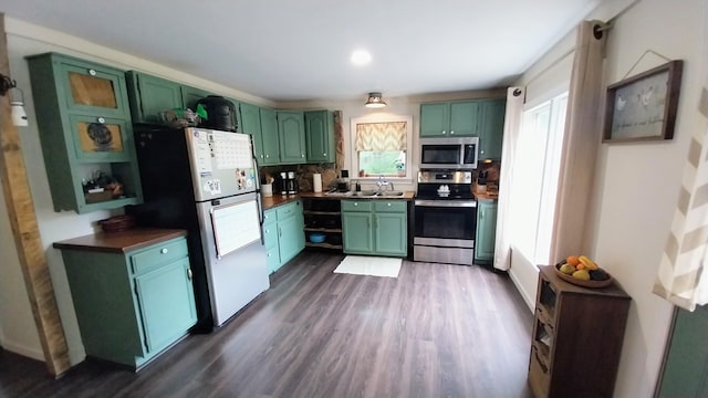 2314 Long Pond Rd, Long Pond, PA 18334 - kitchen featuring green cabinetry, appliances with stainless steel finishes, dark countertops, dark wood-style flooring, and decorative backsplash