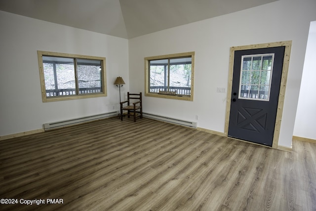 entryway featuring a baseboard heating unit, wood finished floors, and a wealth of natural light