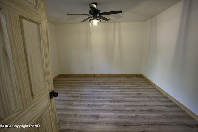 spare room featuring ceiling fan, wood finished floors, and baseboards