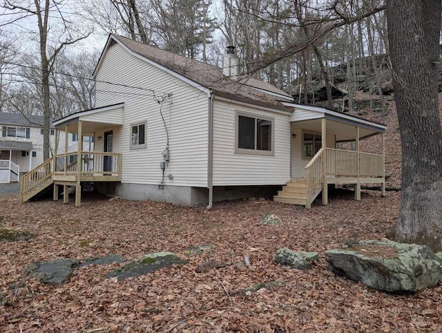 exterior space with covered porch, roof with shingles, and crawl space