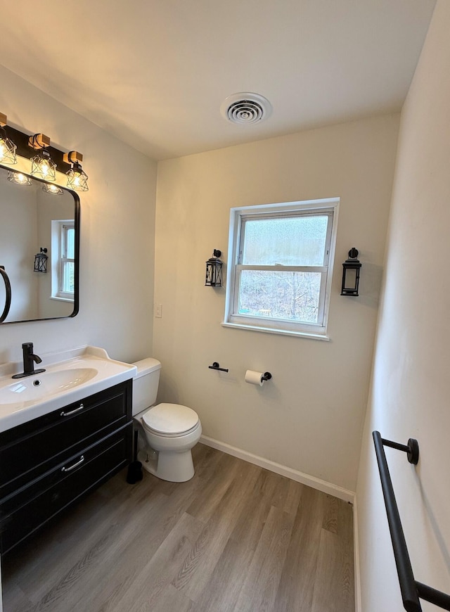 90 Packerton Dam Dr, Lehighton, PA 18235 - half bath featuring vanity, visible vents, toilet, wood finished floors, and baseboards