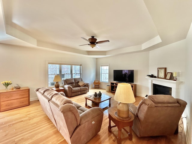 565 Ridge Rd, Bangor, PA 18013 - living room with baseboards, a fireplace, light wood-style flooring, a ceiling fan, and a tray ceiling