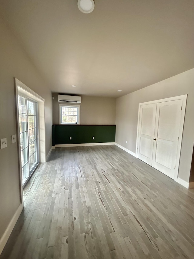 565 Ridge Rd, Bangor, PA 18013 - spare room featuring a wall mounted AC, baseboards, and wood finished floors