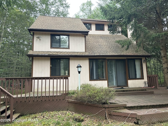 view of front of house with a wooden deck and a shingled roof