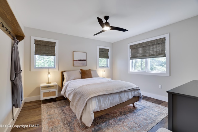 bedroom featuring baseboards, ceiling fan, and wood finished floors