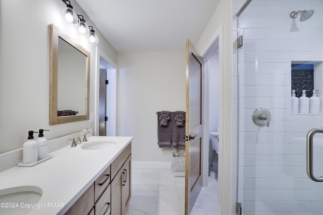 full bathroom featuring double vanity, a sink, marble finish floor, and a stall shower