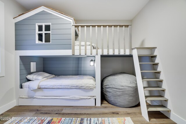 bedroom featuring baseboards and wood finished floors