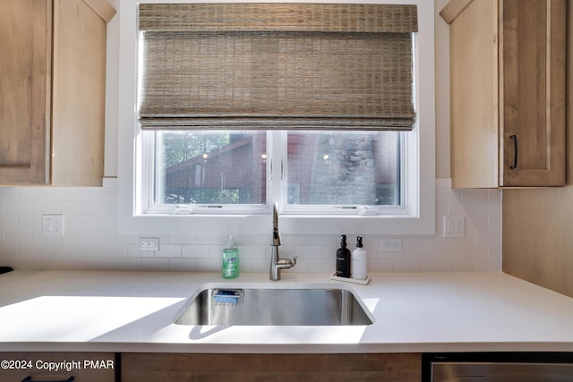 kitchen featuring a sink, light countertops, and decorative backsplash