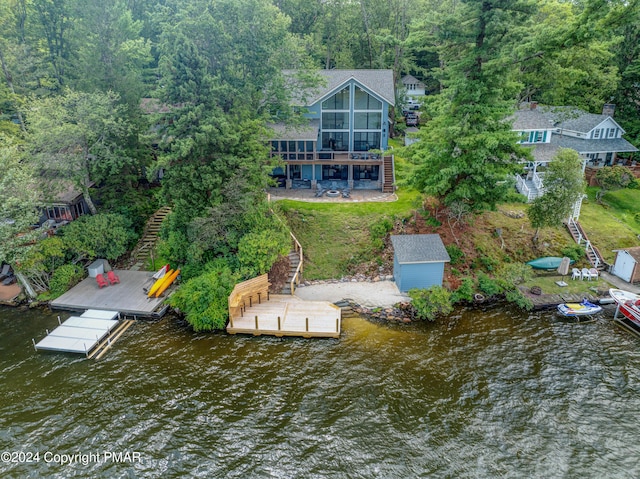 aerial view featuring a water view and a forest view