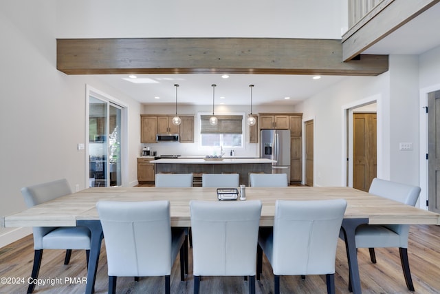 dining room with baseboards, recessed lighting, and wood finished floors