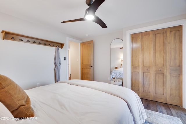 bedroom with a ceiling fan, a closet, and wood finished floors