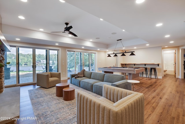 living room featuring recessed lighting, baseboards, a ceiling fan, and light wood finished floors