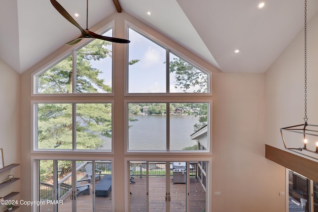 room details with recessed lighting, a water view, and an inviting chandelier