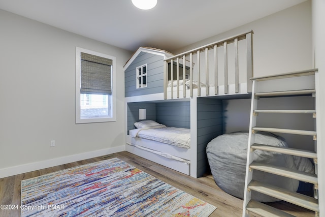 bedroom featuring baseboards and wood finished floors