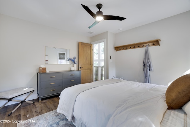 bedroom featuring a ceiling fan, wood finished floors, and visible vents