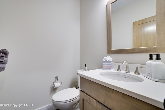 bathroom featuring toilet and vanity