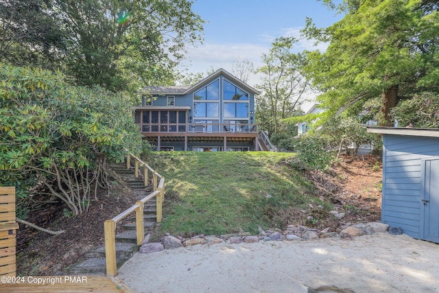 back of house featuring a wooden deck and stairway