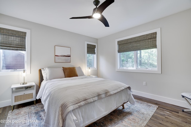 bedroom with baseboards, ceiling fan, and wood finished floors