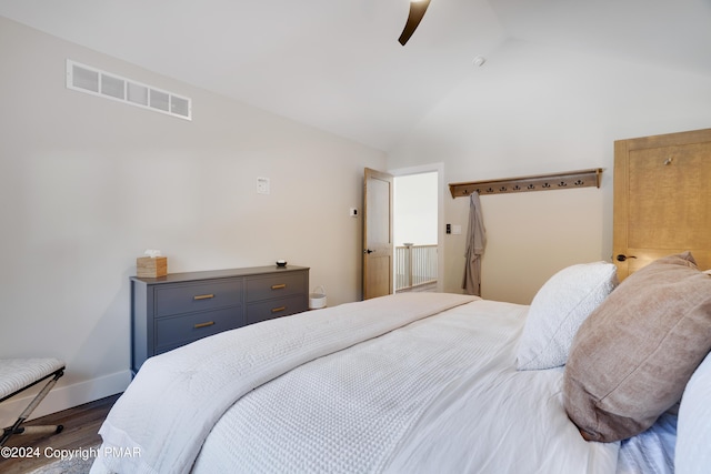 bedroom with visible vents, wood finished floors, baseboards, high vaulted ceiling, and a ceiling fan
