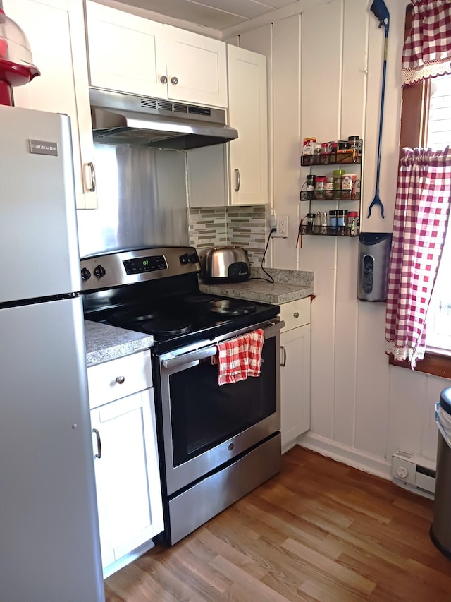 618 Mccabe Ln, Saylorsburg, PA 18353 - kitchen featuring appliances with stainless steel finishes, under cabinet range hood, white cabinetry, light wood-style floors, and light countertops