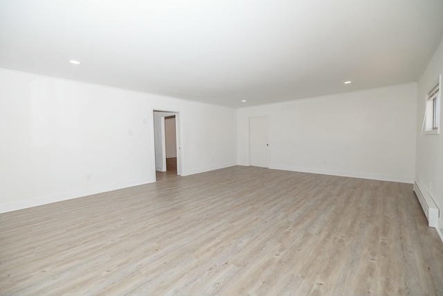 spare room featuring recessed lighting, light wood-style flooring, and baseboards