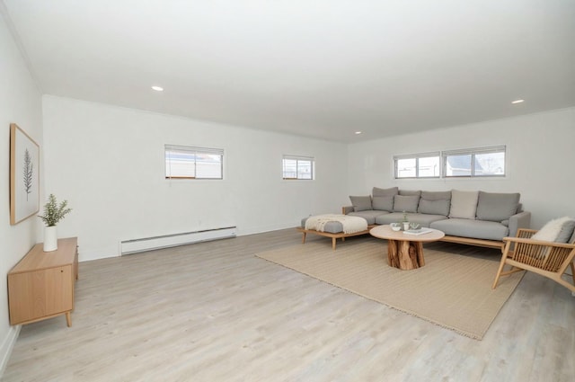 living area with recessed lighting, light wood-style flooring, and a baseboard radiator