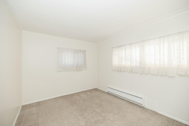 spare room featuring baseboards, carpet floors, and baseboard heating