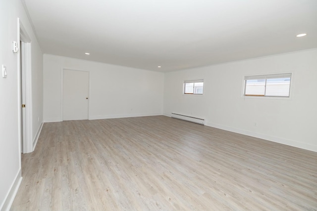 spare room with recessed lighting, baseboards, a baseboard heating unit, and light wood-style floors