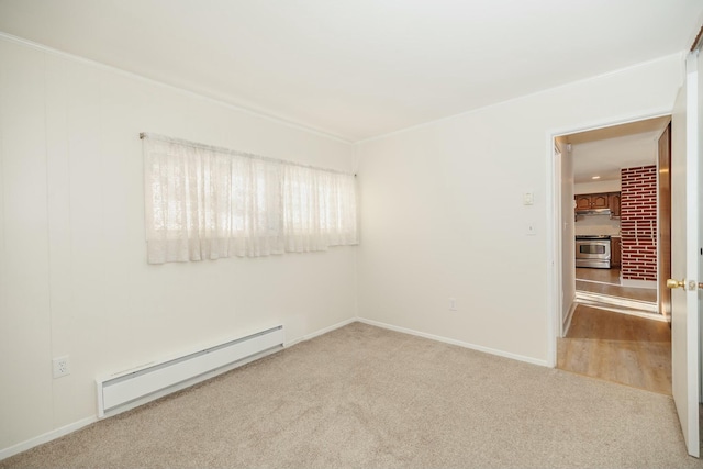 carpeted empty room featuring a baseboard heating unit and baseboards