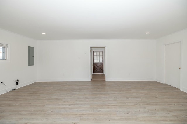 unfurnished room with electric panel, light wood-type flooring, recessed lighting, and crown molding