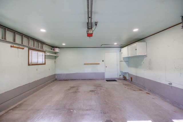 garage with recessed lighting and a garage door opener