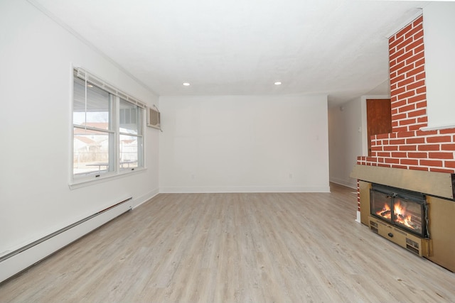 unfurnished living room with baseboard heating, a fireplace, baseboards, and wood finished floors