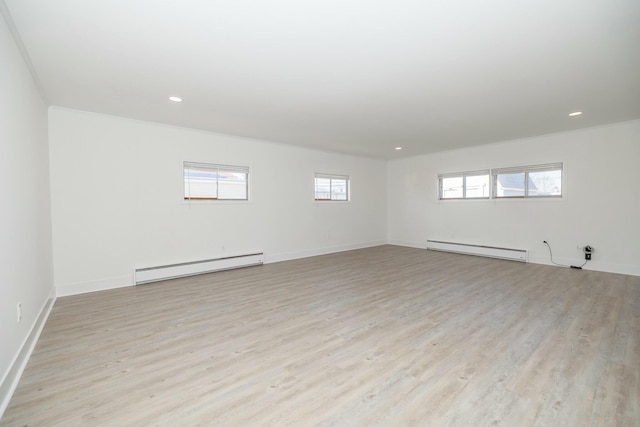 unfurnished room featuring light wood finished floors, recessed lighting, and baseboard heating