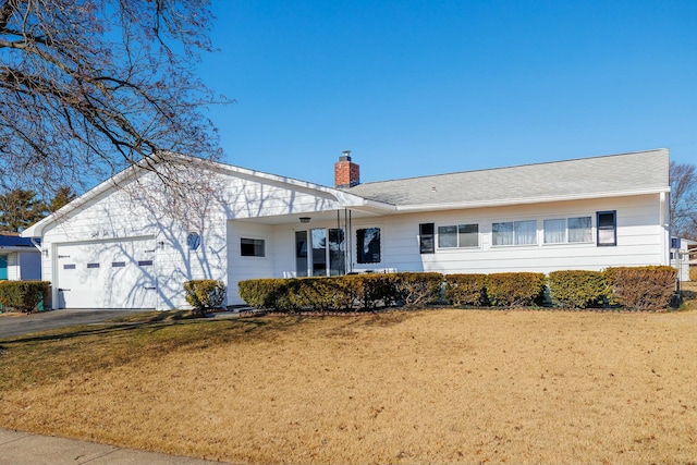 ranch-style house with aphalt driveway, a front yard, a chimney, and an attached garage