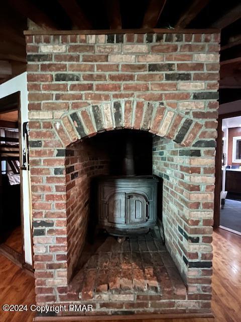 room details featuring a wood stove and wood finished floors