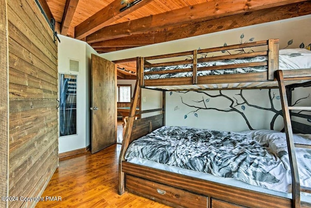 bedroom with wooden ceiling and wood finished floors